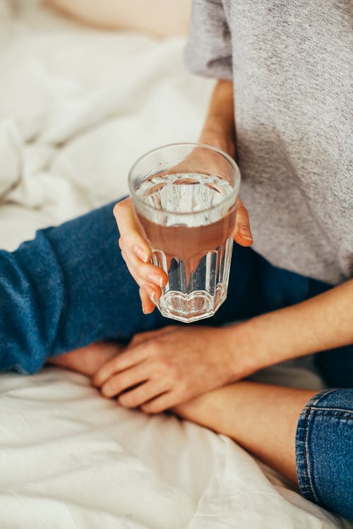 hands with glass water