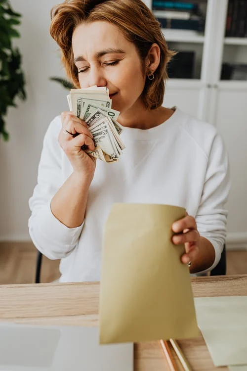 woman smelling money