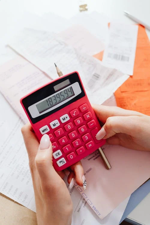 hands with calculator checking bills