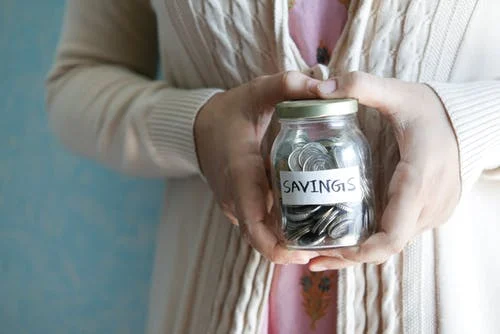 hands with savings jar