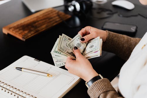 womans hands counting money