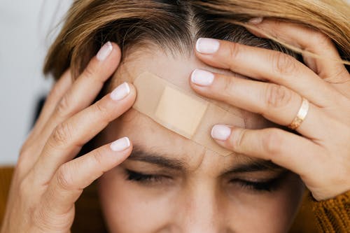 woman with bandaid on head