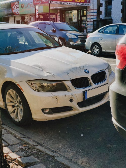 white car with dents