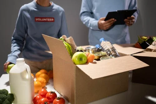 volunteer packing food box