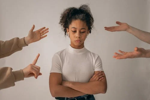 woman with fingers pointed at her