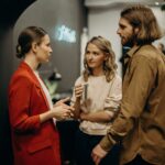 three co-workers standing and talking