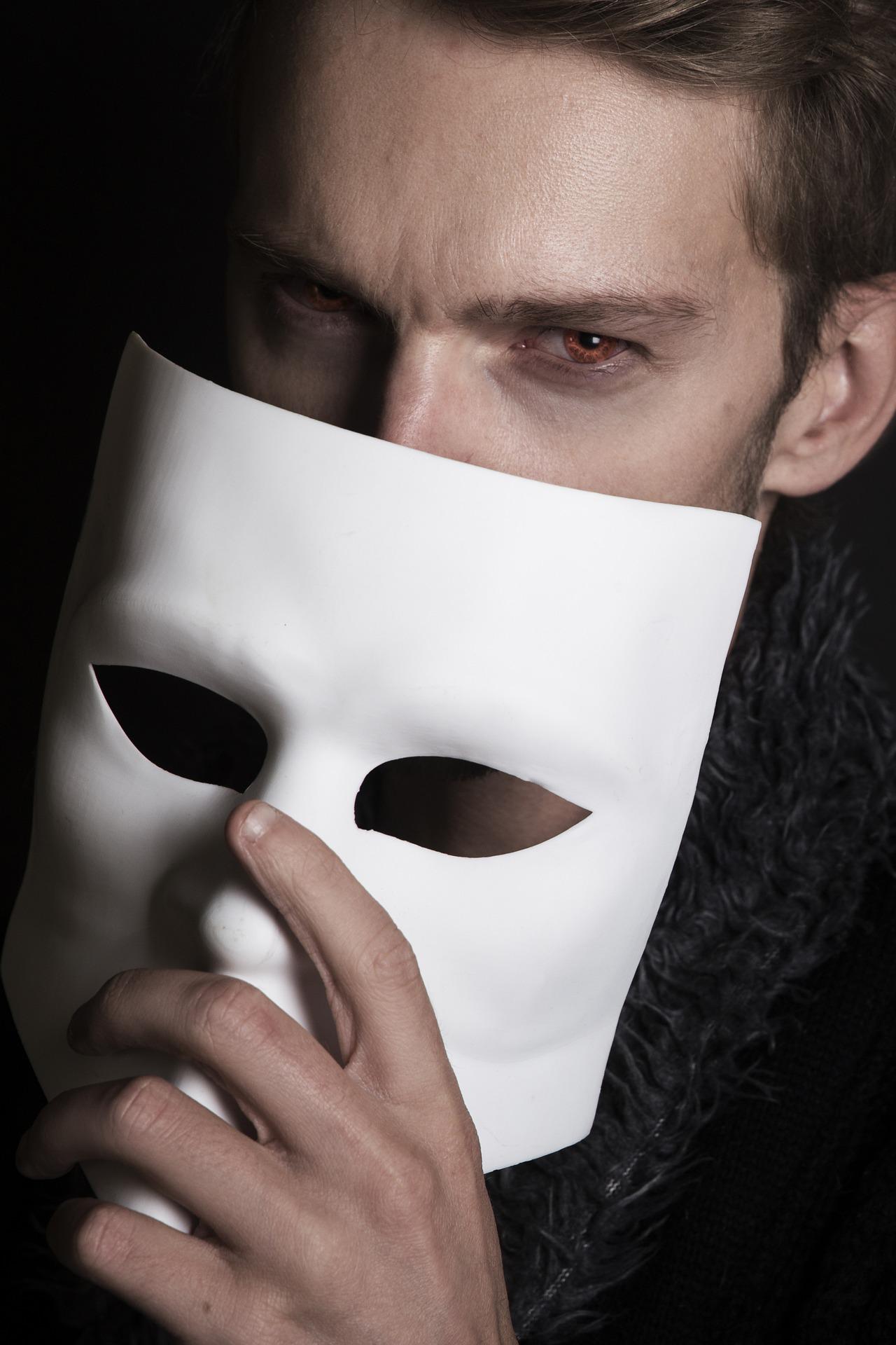 Man holding up a mask to face